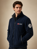 Man in navy blue fleece jacket with stand-up collar, three-quarter view