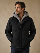 Man in black padded winter jacket with gray fleece hood, three-quarter view