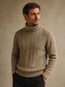 Man wearing a cable-knit turtleneck with wide ribbed collar in khaki, three-quarter view