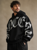 Man draagt heren oversized hoodie met gothic letterprint, driekwartsaanzicht