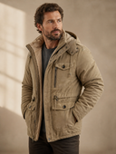 Man in khaki parka with pockets and fleece lining, three-quarter view